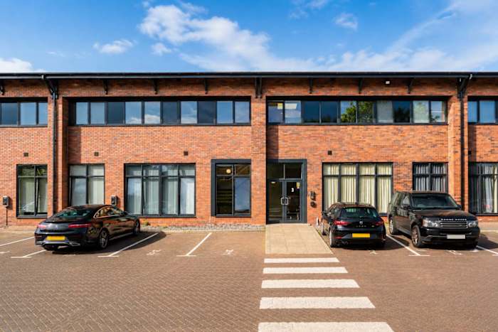 The building, with the two free parking spaces on site